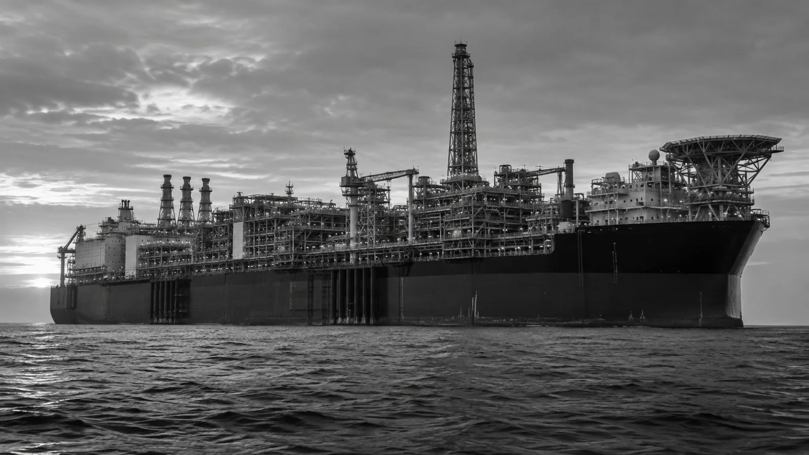 A floating production unit sits offshore in muted morning light / TokenPost.ai