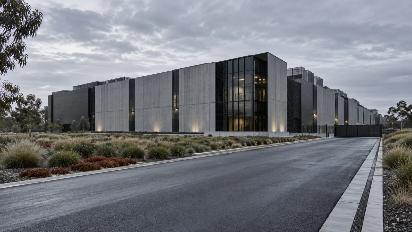 A Melbourne data center facade beside a quiet access road / TokenPost.ai