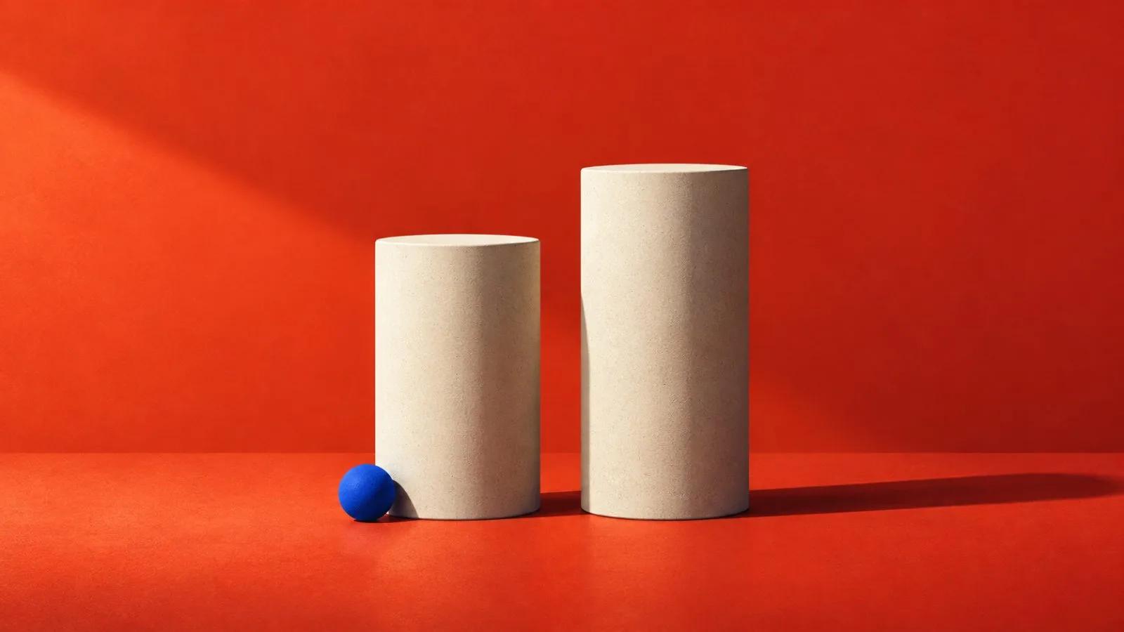 Two ceramic columns stand at different heights against a vermilion backdrop / TokenPost.ai