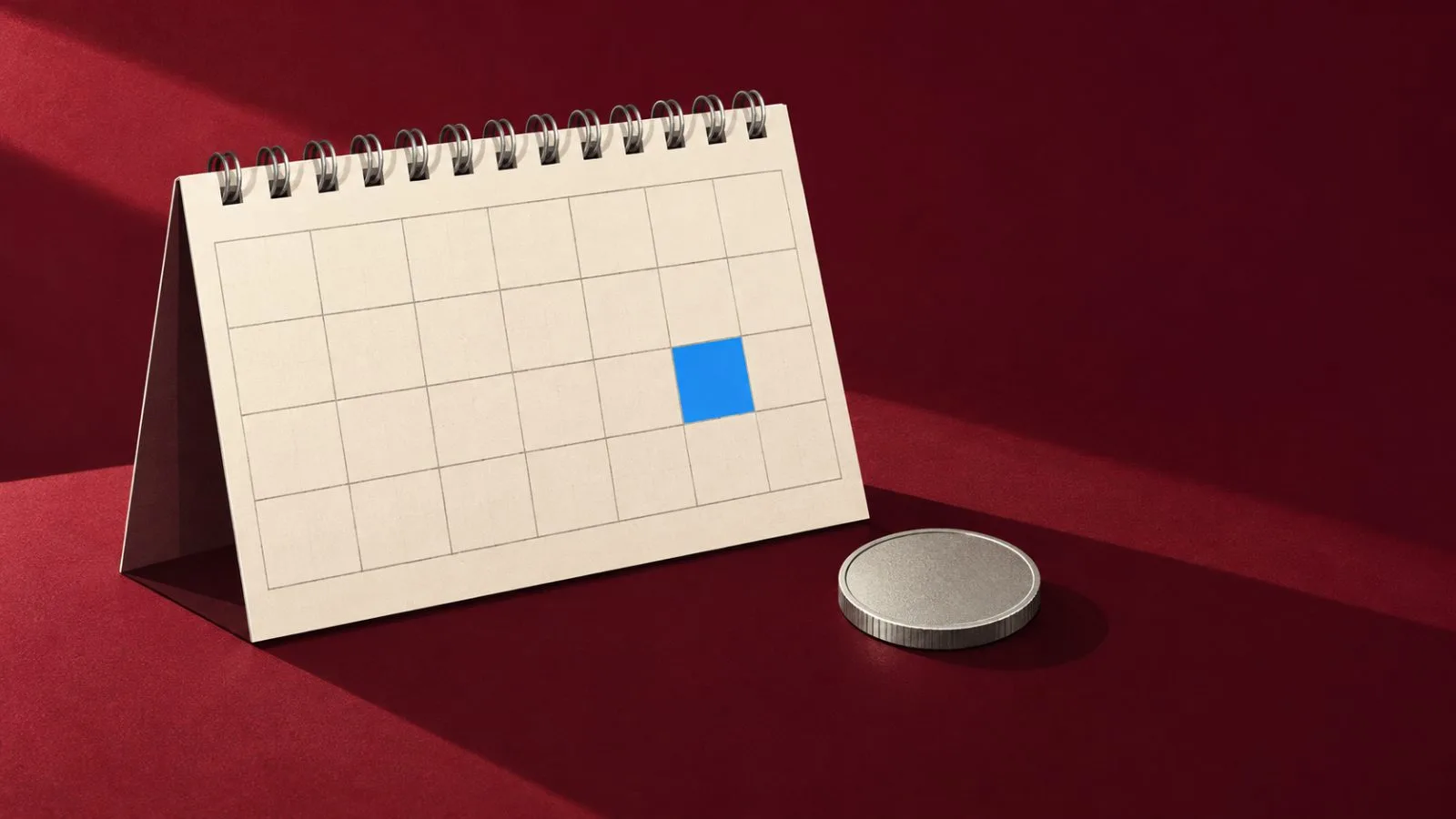 A silver coin rests beside a highlighted calendar square / TokenPost.ai