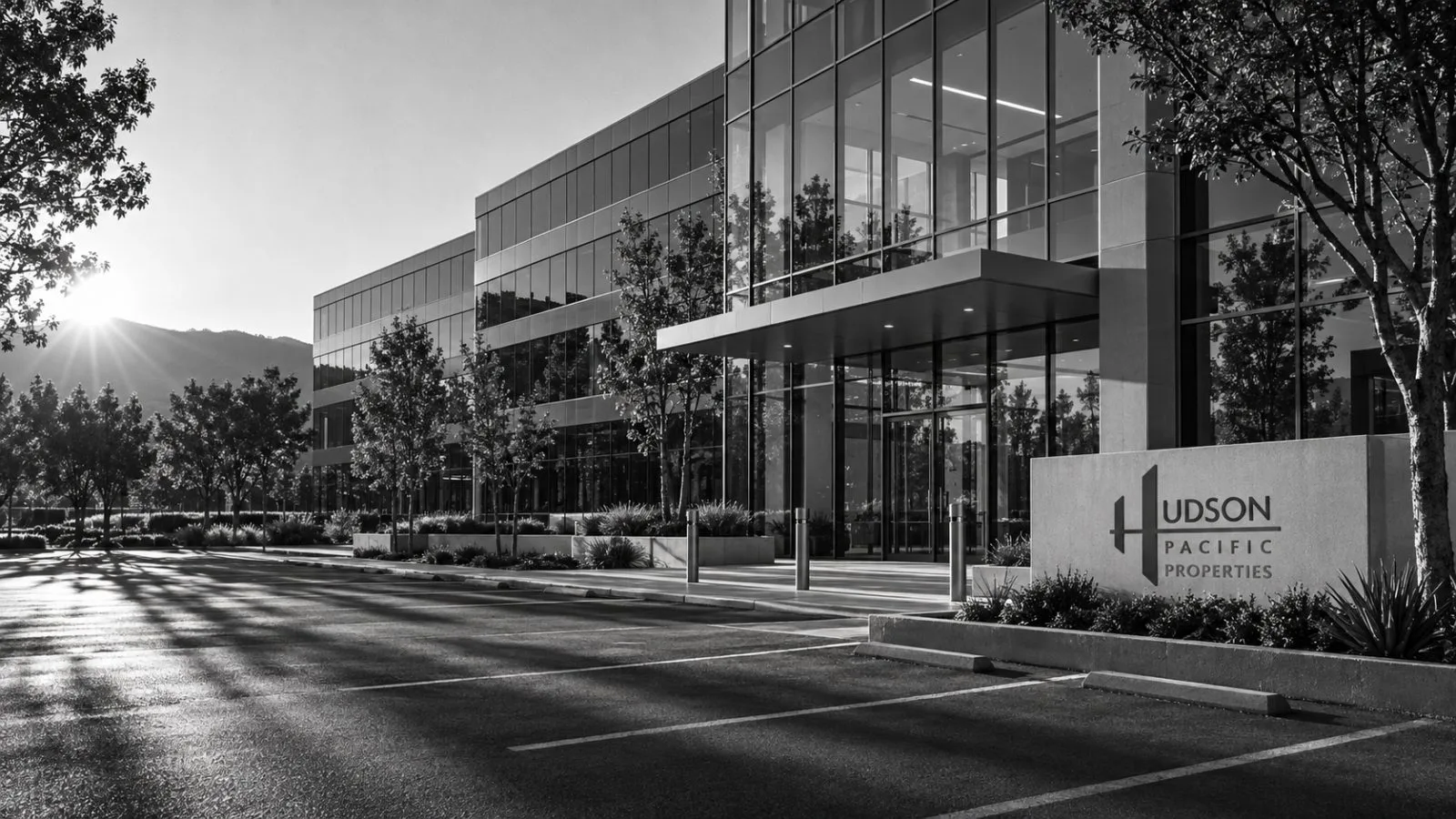 An empty office tower reflects late afternoon light over North San Jose / TokenPost.ai