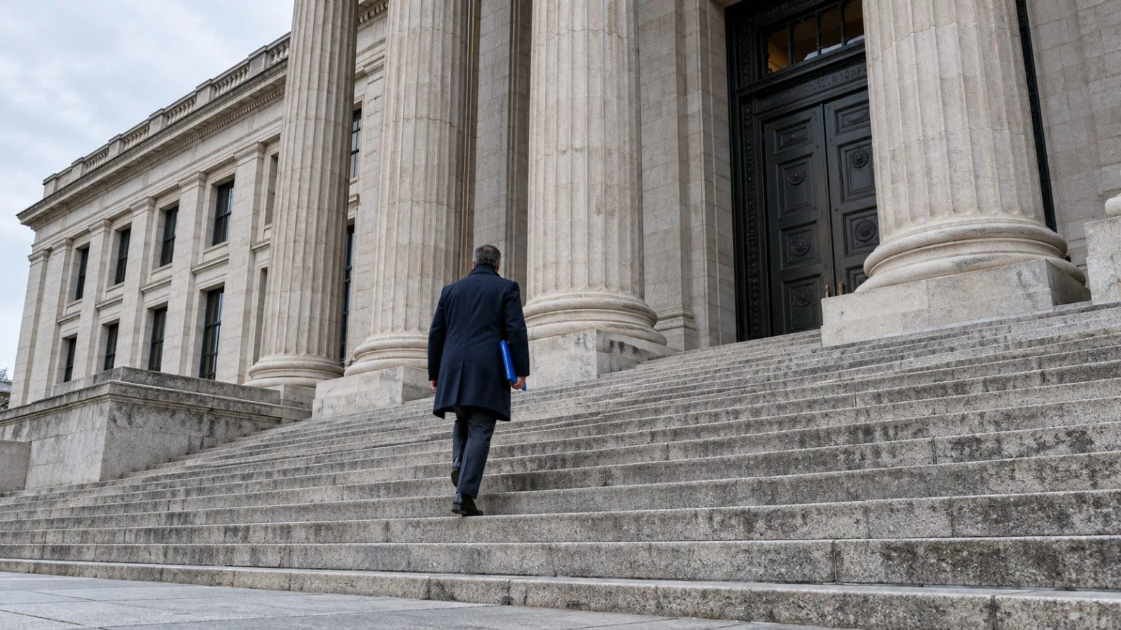 An anonymous visitor approaches the stone steps of a federal courthouse / TokenPost.ai