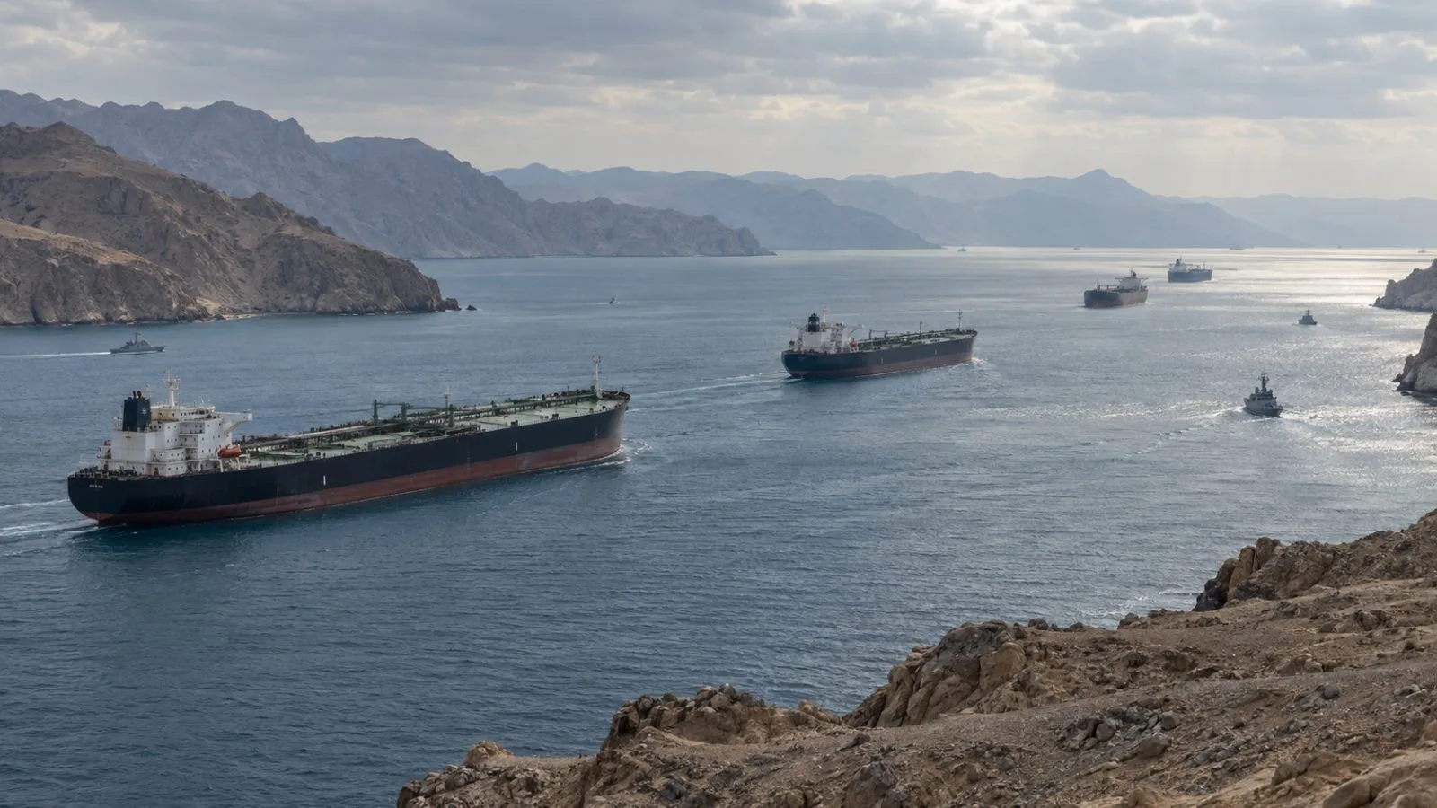 Commercial tankers pass the Strait of Hormuz under dawn light / TokenPost.ai