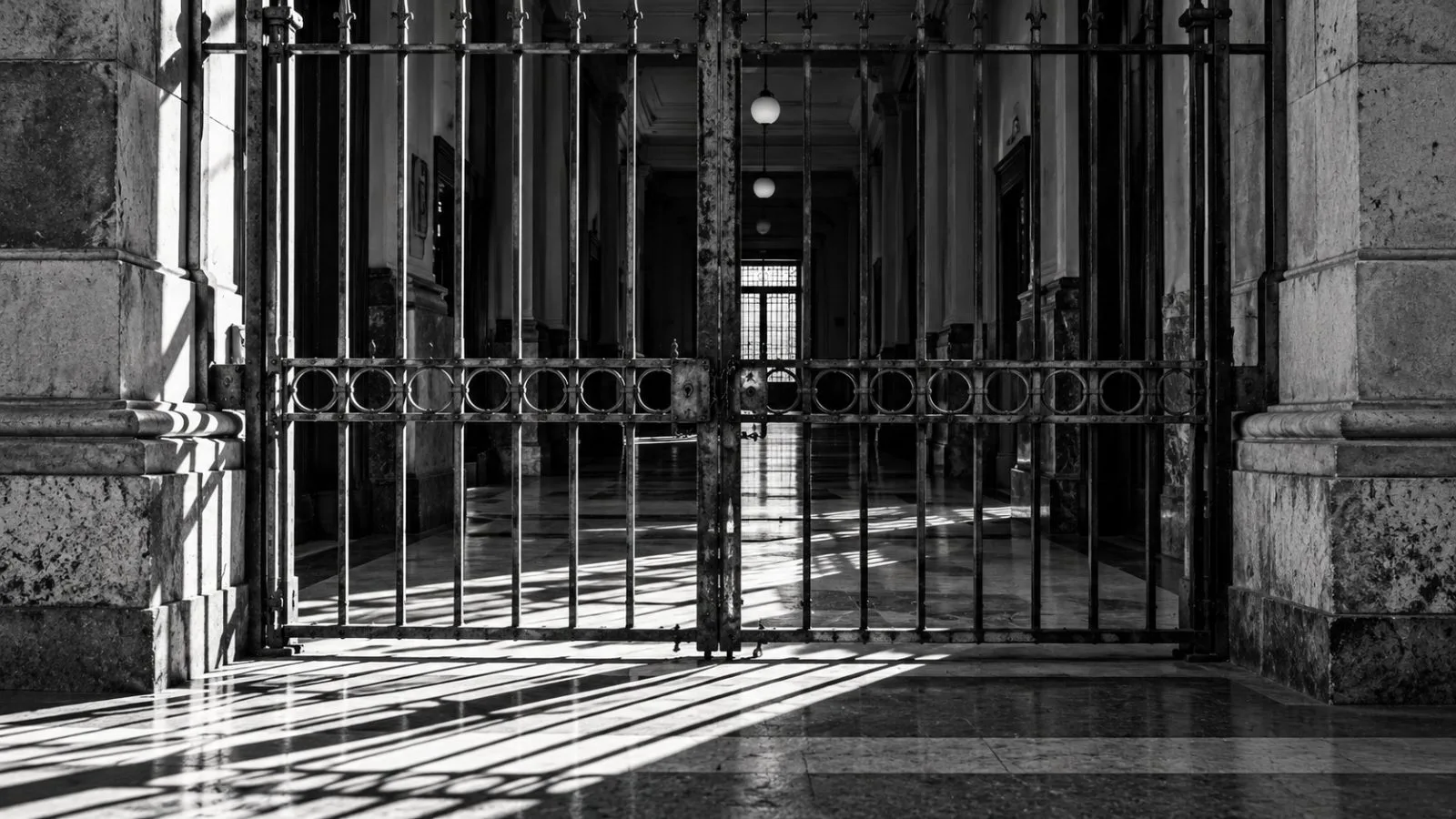A courthouse security gate closes across an empty corridor / TokenPost.ai