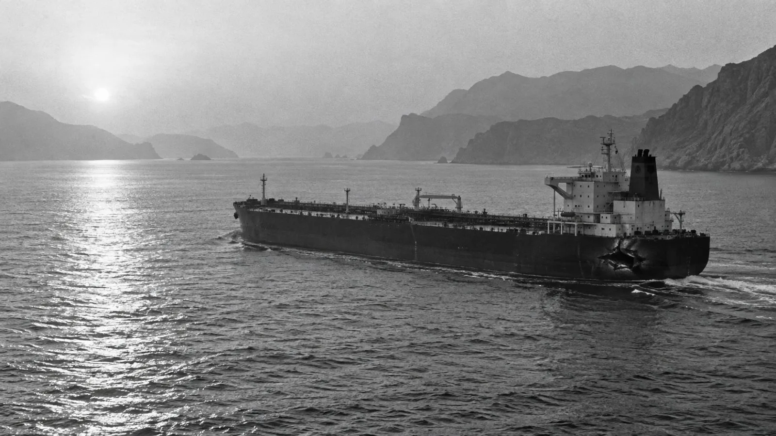 An oil tanker crosses calm water near a distant coastline / TokenPost.ai