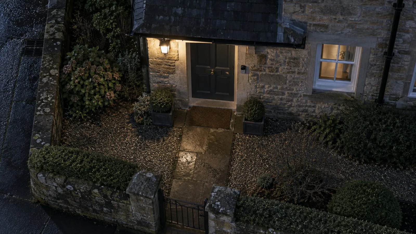 Stone house entrance with a small doorbell camera at night / TokenPost.ai